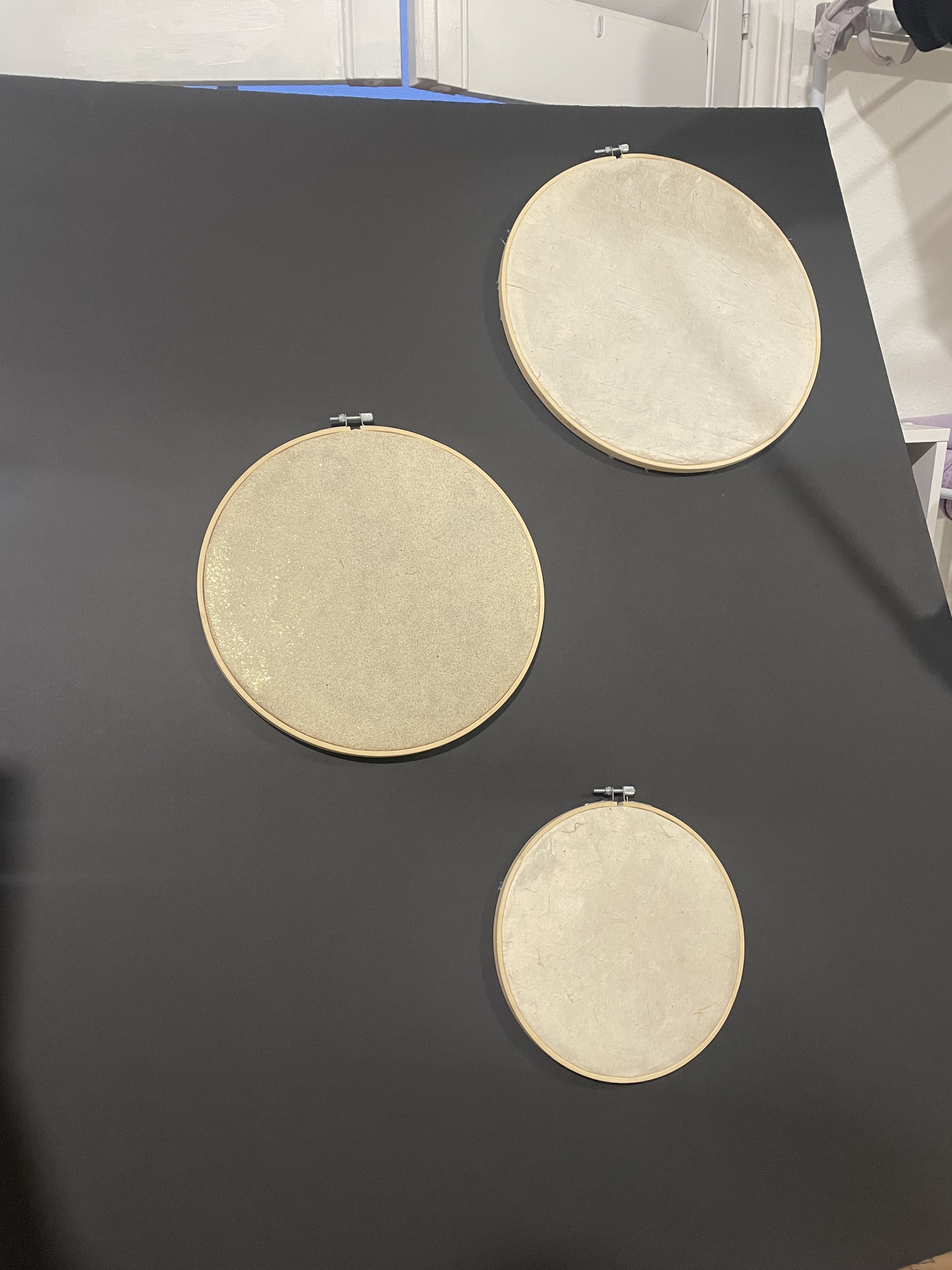 Three embroidery hoops with hanji paper